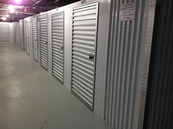 a row of metal doors in a storage room